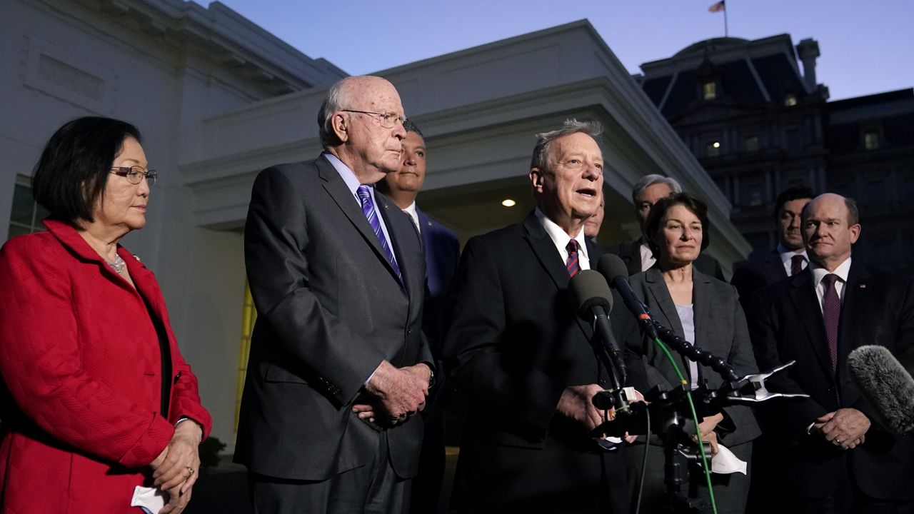 Sen. Dick Durbin, D-Ill., center, chairman of the Senate Judiciary Committee, speaks with members of the press after he and Democratic members of the committee met with President Joe Biden to discuss the upcoming Supreme Court vacancy, Thursday, Feb. 10, 2022. (AP Photo/Patrick Semansky)