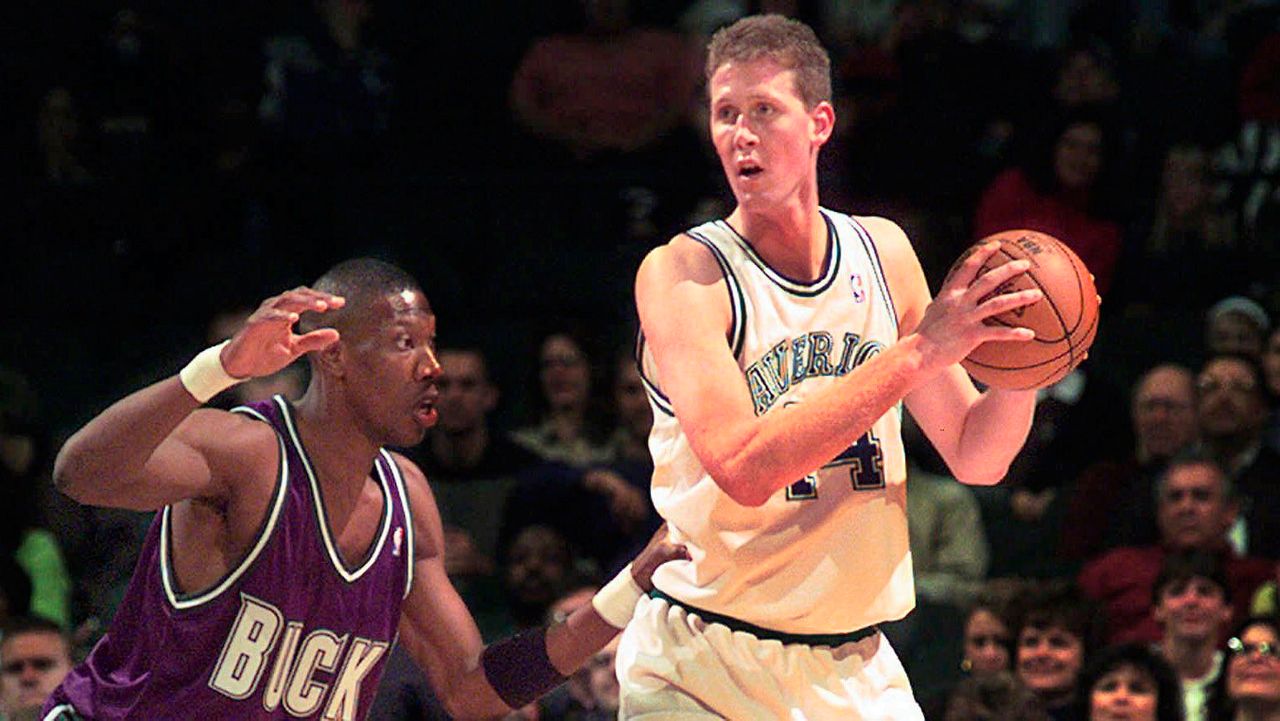 FILE- In this Nov. 22, 1997, file photo, Dallas Mavericks' Shawn Bradley (44) looks to pass as Milwaukee Bucks' Ervin Johnson (40) defends during the first quarter of an NBA basketball game at the Reunion Arena in Dallas. Former NBA player Shawn Bradley was paralyzed when he was struck from behind by a vehicle while riding a bike near his Utah home, saying in a statement nearly two months after the accident he intended to bring awareness to bicycle safety. (AP Photo/LM Otero, File)