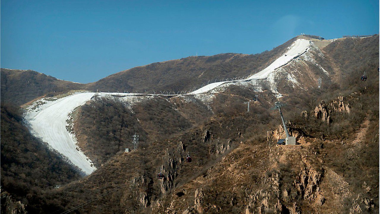 Artificial snow only covers the runs on the slopes above Beijing