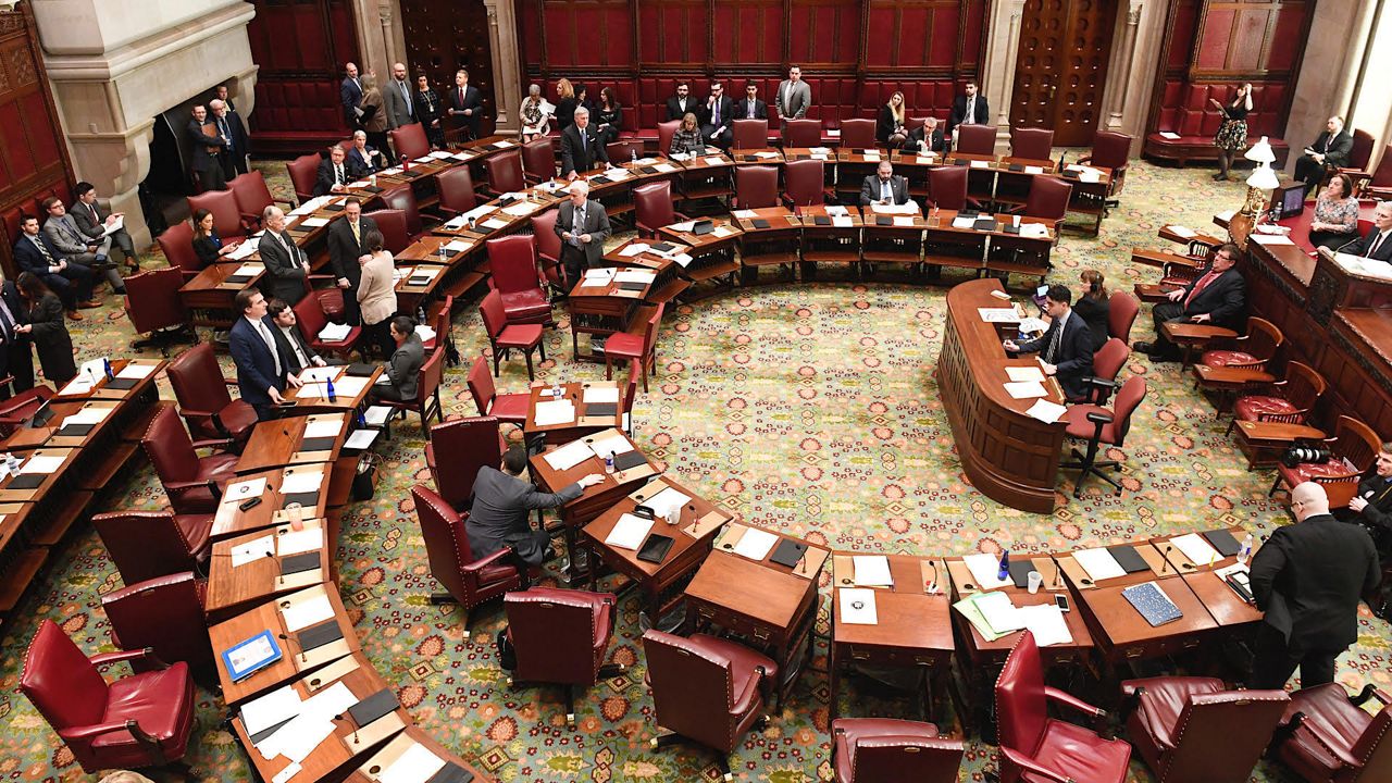 Members of the New York state Senate work in the Senate Chamber at the state Capitol Tuesday, March 26, 2019, in Albany, N.Y. (AP Photo/Hans Pennink)