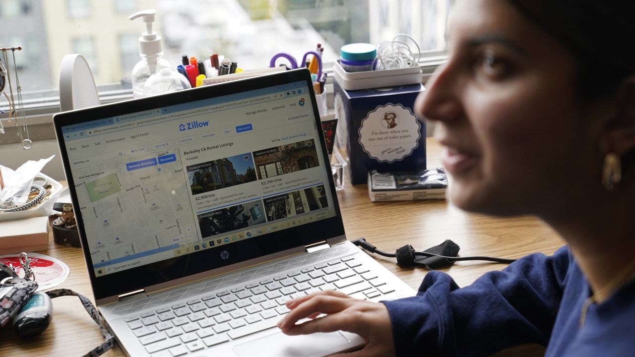 University of California, Berkeley freshman Sanaa Sodhi talks with a friend in her on-campus dorm room while searching online for apartments in Berkeley, Calif., Tuesday, March 29, 2022. (AP Photo/Eric Risberg)