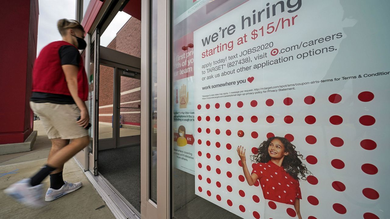 This is a help wanted sign on the door of a Target store in Uniontown, Pa., on Wednesday, Sept. 2, 2020. (AP Photo/Gene J. Puskar)