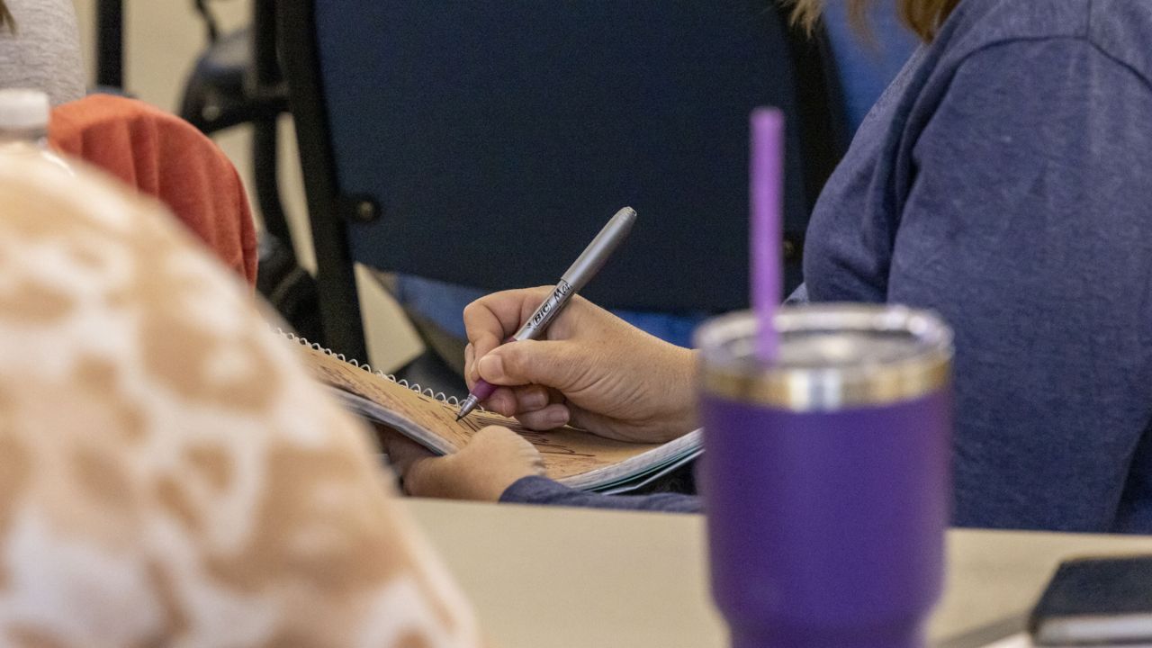 A preservice teacher takes notes during an ethics seminar provided by the Athens State college of education, Tuesday, Oct. 11, 2022, in Athens, Ala. (AP Photo/Vasha Hunt)