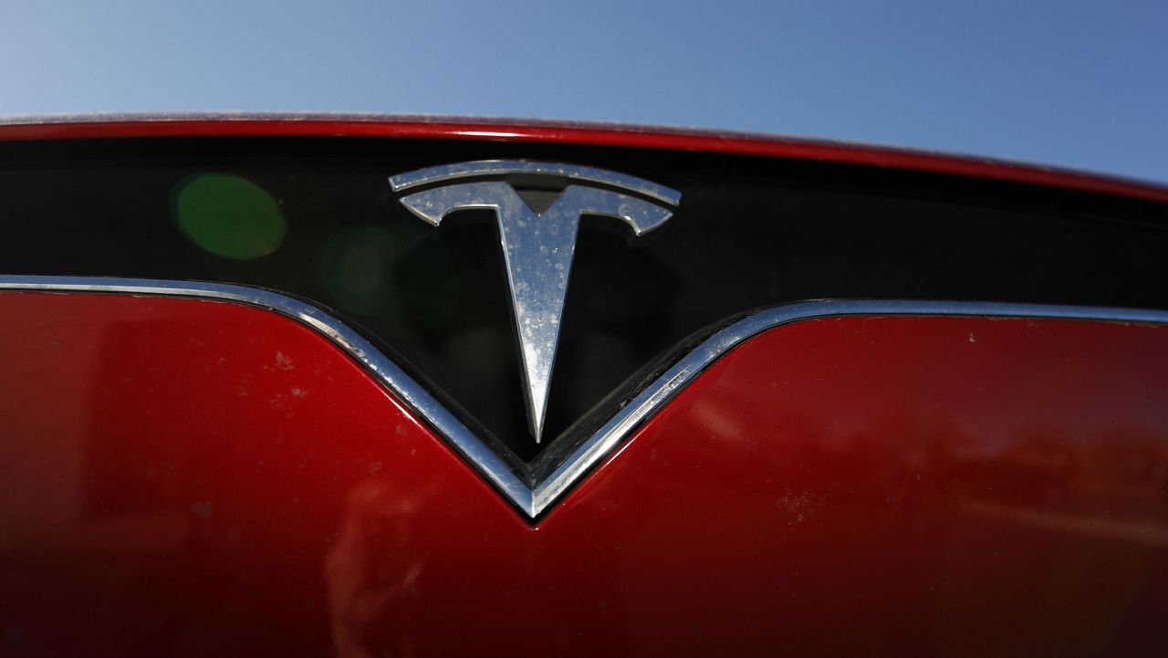 In this Sunday, Feb. 2, 2020, photograph, the company logo shoines off the grille of an unsold 2020 Model X at a Tesla dealership in Littleton, Colo. (AP Photo/David Zalubowski)