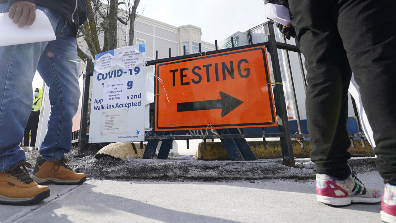 FILE: People wait in line to be tested for the COVID-19 virus outside the Bowdoin Street Health Center, Wednesday, Jan. 12, 2022, in Boston. (AP Photo/Charles Krupa)
