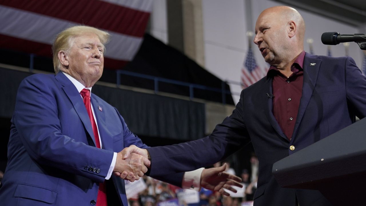 Former President Donald Trump greets Pennsylvania Republican gubernatorial candidate Doug Mastriano on stage at a rally in Wilkes-Barre, Pa., Saturday, Sept. 3, 2022. (AP Photo/Mary Altaffer)