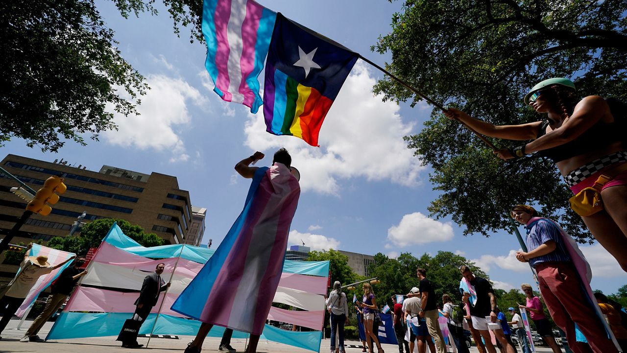 In this Thursday, May 20, 2021 file photo, demonstrators gather on the steps to the State Capitol to speak against transgender-related legislation bills being considered in the Texas Senate and Texas House in Austin, Texas. (AP Photo/Eric Gay, File)