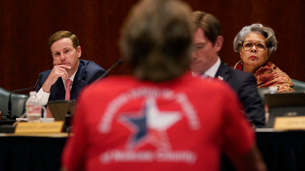 Texas State Rep. Trent Ashby, R-Lufkin, left, and Rep. Senfronia Thompson, D-Houston, right, listen to testimony during a hearing over an election bill at the Texas Capitol in Austin, Texas, Monday, Aug. 23, 2021. (AP Photo/Eric Gay)