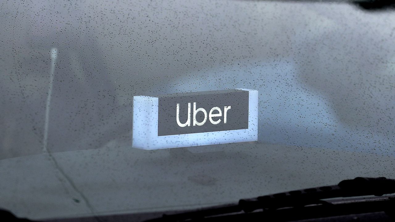 An Uber sign is displayed inside a car in Chicago.