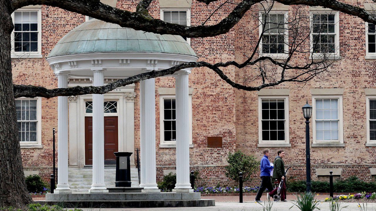 University of North Carolina system schools have been closed since March. An AP photo from March 18 shows people moving out of the Chapel Hill campus after the coronavirus pandemic shut down the university. (AP Photo/Gerry Broome)