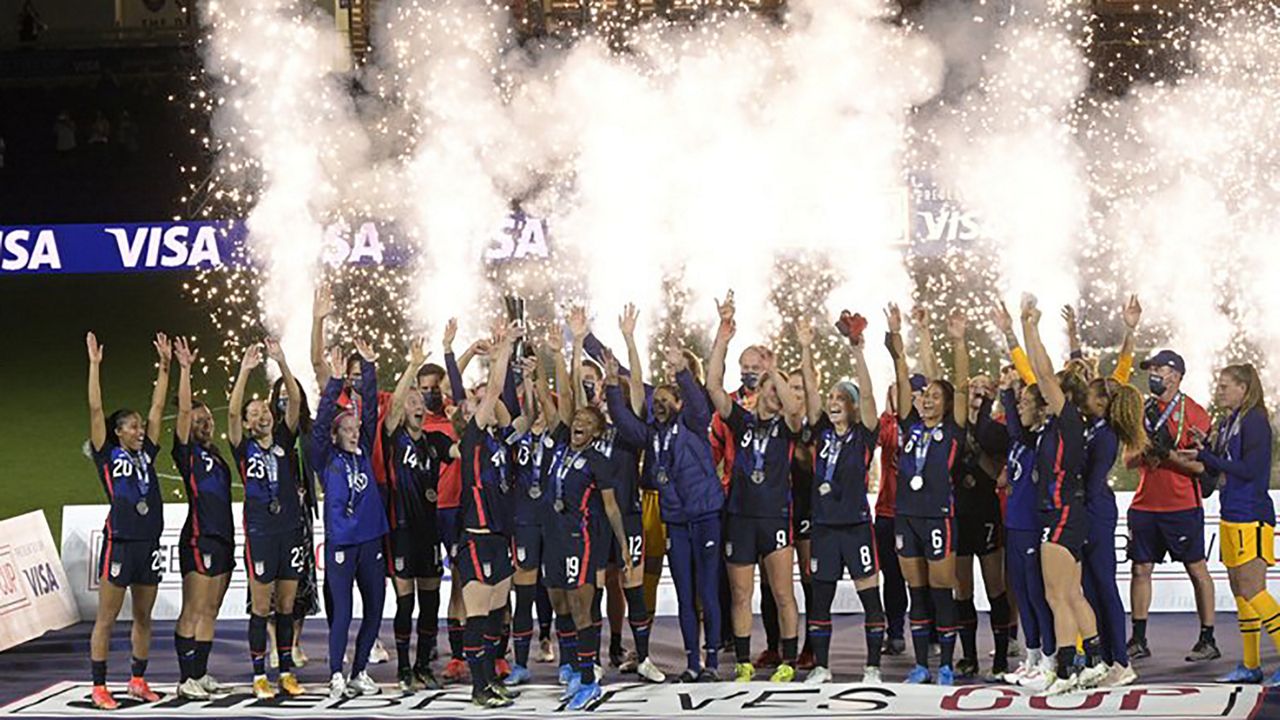 United States players and coaches celebrate during the trophy presentation after a SheBelieves Cup women's soccer match against Argentina, Wednesday, Feb. 24, 2021, in Orlando, Fla. (AP Photo/Phelan M. Ebenhack)