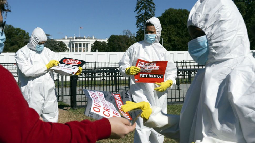 A group protests the ongoing outbreak of coronavirus in the White House, Thursday, Oct. 8, 2020, outside the White House in Washington. (AP Photo/Jacquelyn Martin)