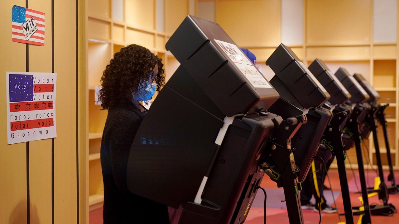 voter at a voting booth casting a ballot