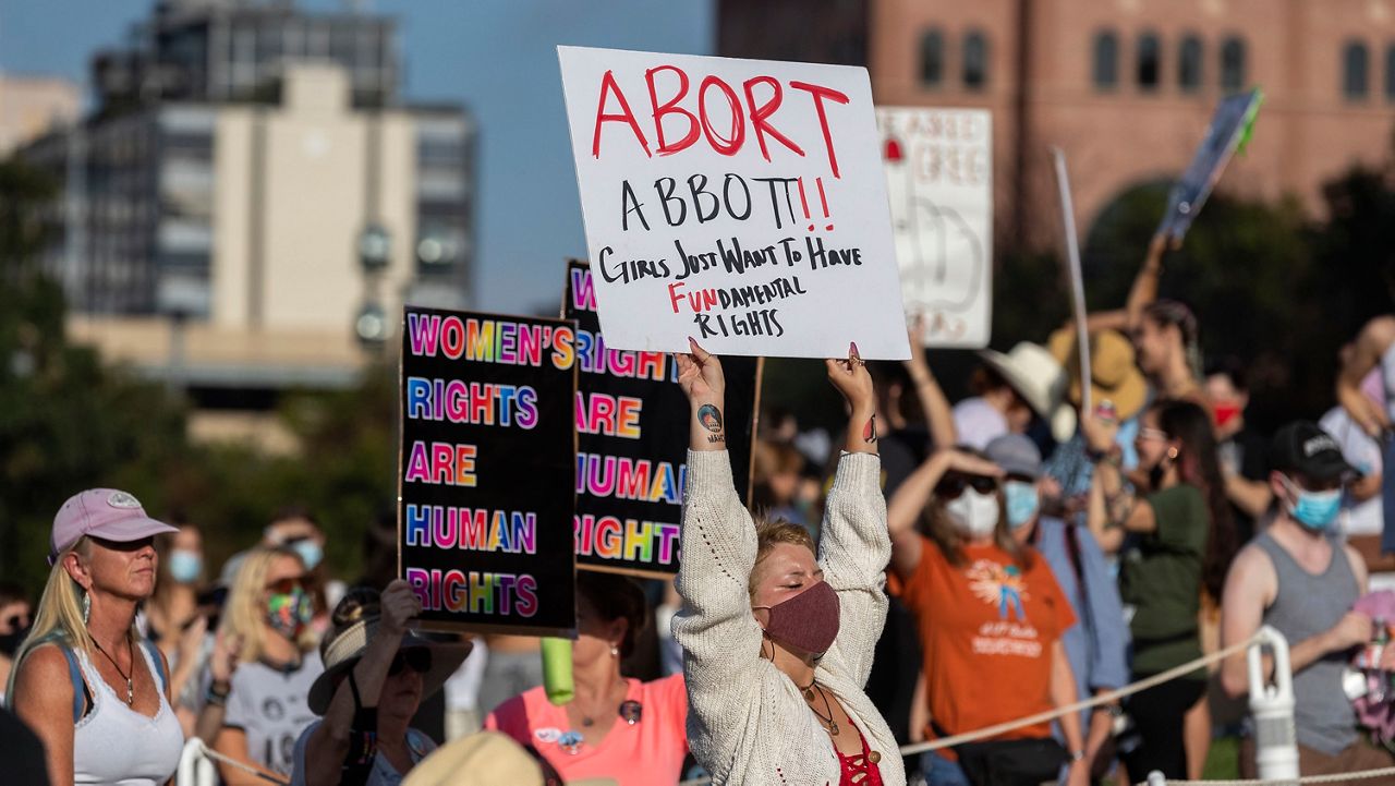 People attend the Women's March ATX rally, Saturday, Oct., 2, 2021, at the Texas State Capitol in Austin, Texas. The march was a response to controversial legislation recently passed by Texas lawmakers which has banned most abortions in Texas. (AP Photo/Stephen Spillman)