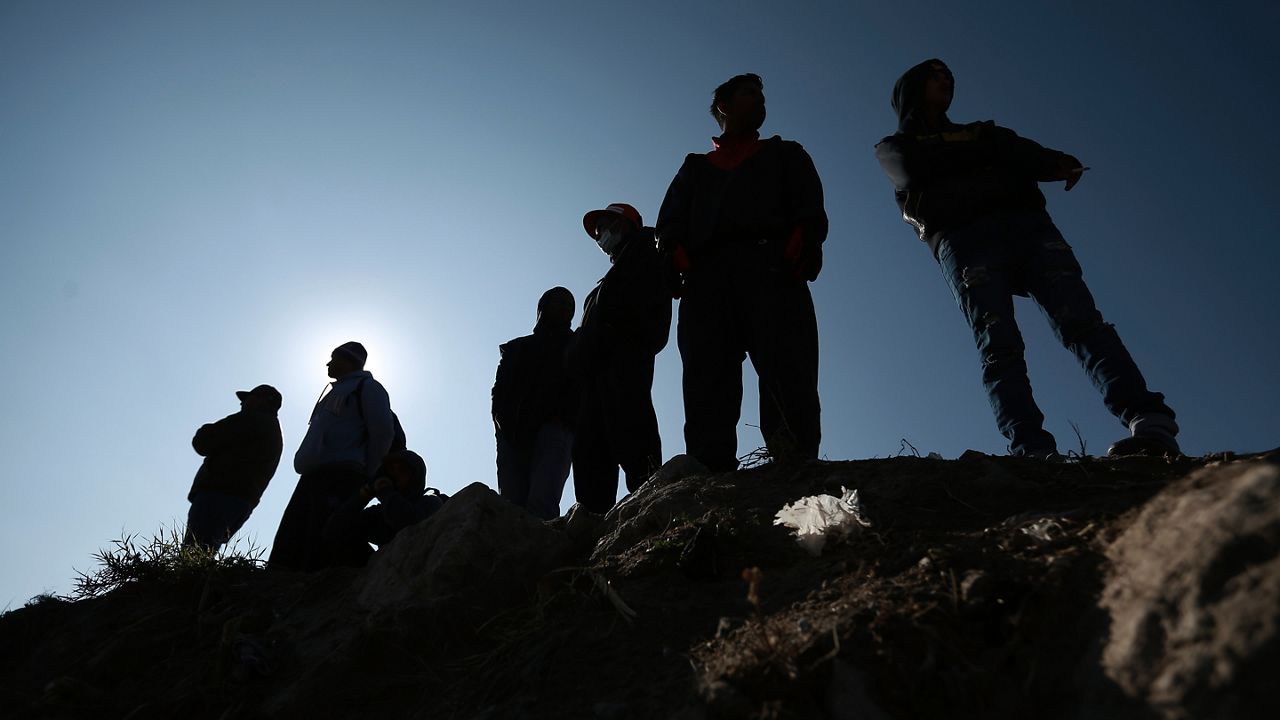 Migrants stand near the U.S.-Mexico border in Ciudad Juarez, Mexico, Monday, Dec. 19, 2022. Pandemic-era immigration restrictions in the U.S. known as Title 42 are set to expire on Dec. 21. (AP Photo/Christian Chavez)