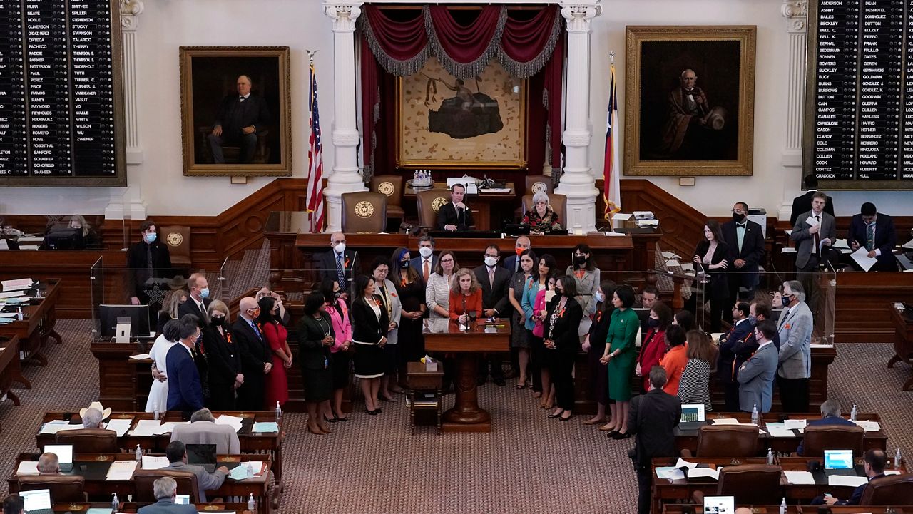 Texas state Rep. Donna Howard, D-Austin, center at lectern, stands with fellow lawmakers in the House Chamber, Wednesday, May 5, 2021, in Austin, Texas, as she opposes a bill introduced that would ban abortions as early as six weeks and allow private citizens to enforce it through civil lawsuits, under a measure given preliminary approval by the Republican-dominated House. The move would have Texas join about a dozen other Republican-led states to pass so-called "heartbeat bills" which have been mostly blocked by federal courts. (AP Photo/Eric Gay)