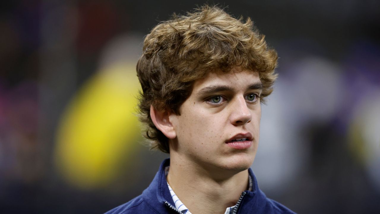 Arch Manning, son of Cooper Manning and nephew of Peyton and Eli Manning, walks on the field before an NFL football game between the New Orleans Saints and the Los Angeles Rams in New Orleans, Sunday, Nov. 20, 2022. (AP Photo/Butch Dill)