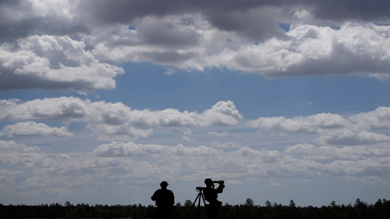 Members of the U.S. Secret Service keep watch before President Joe Biden spoke at the Red Butte Airfield Tuesday, Aug. 8, 2023, in Tusayan, Ariz. (AP Photo/John Locher)