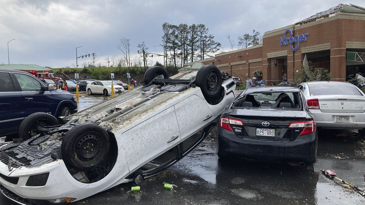 A car is upturned in a Kroger parking lot after a severe storm swept through Little Rock, Ark., Friday, March 31, 2023. (AP Photo/Andrew DeMillo)