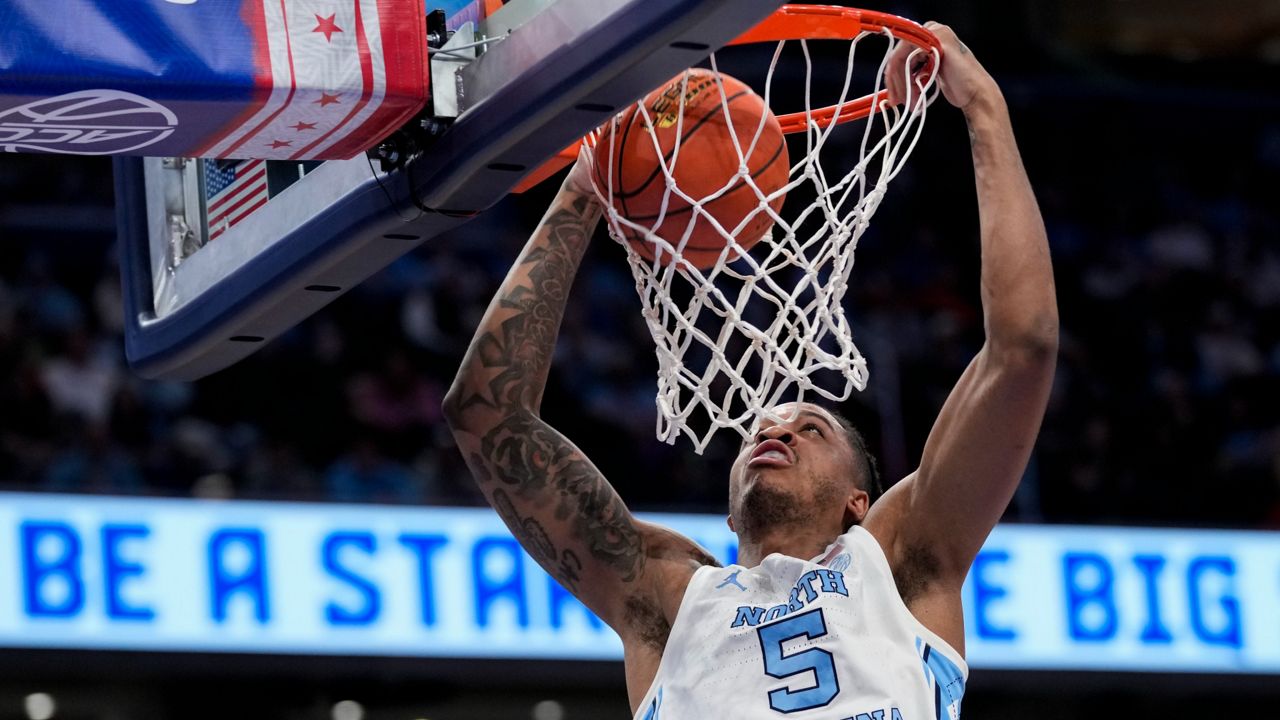 North Carolina forward Armando Bacot throws down a dunk for 2 of his 14 points as the Tar Heels crushed the Seminoles on the boards and in scoring in the quarterfinals of the Atlantic Coast Conference tournament, Thursday, March 14, 2024, in Washington. (AP Photo/Susan Walsh)