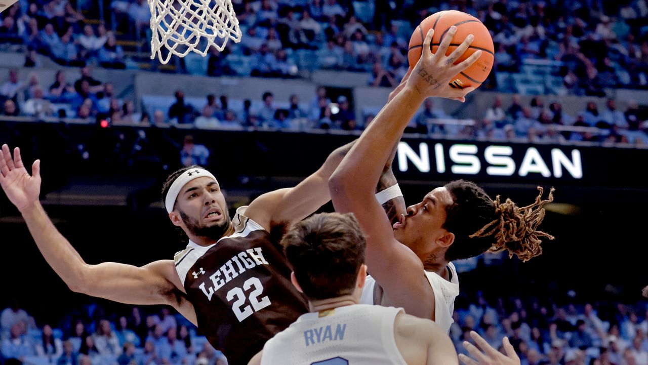 North Carolina forward Armando Bacot, right, grabs a rebound against Lehigh guard Tyler Whitney-Sidney (22) during the second half of an NCAA college basketball game Sunday, Nov. 12, 2023, in Chapel Hill, N.C. (AP Photo/Chris Seward)