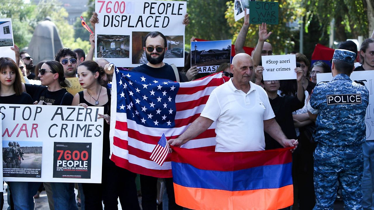 Demonstrators with American and Armenian national flags gather at the Cafesjian Center for the Arts where U.S. House of Representatives Nancy Pelosi delivers her speech in Yerevan, Armenia, Sunday, Sept. 18, 2022. (Stepan Poghosyan/Photolure via AP)