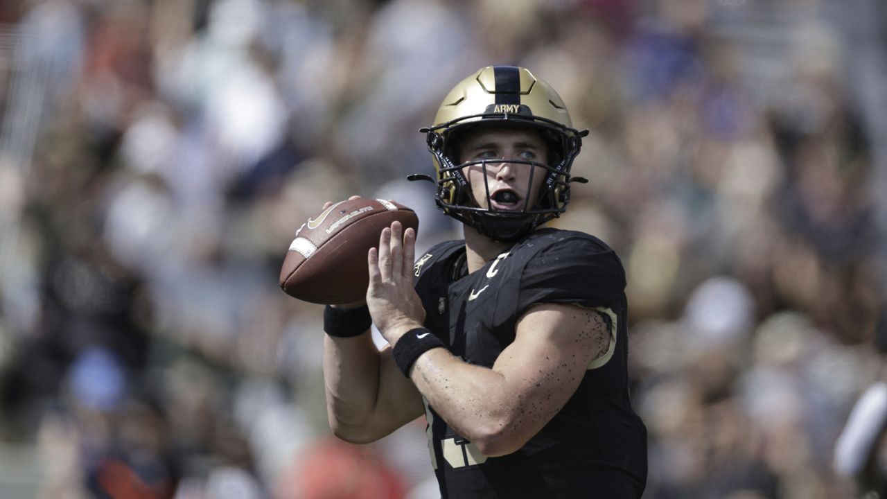 bryson daily looks to pass the football in an army game