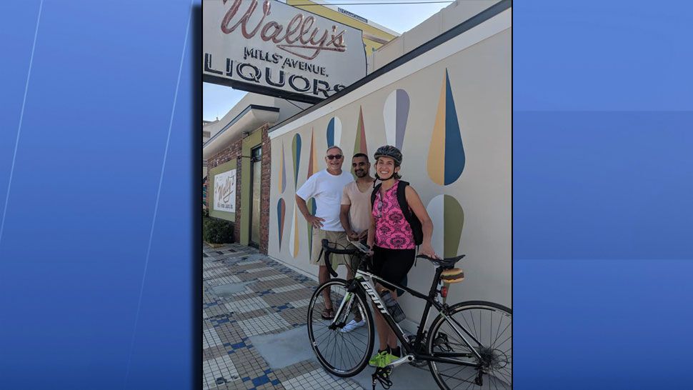 Spectrum News' Ybeth Bruzual with Wally's owner Minesh Patel and artist Reid Pasternack outside of Wally's. (Ybeth Bruzual, Spectrum News)
