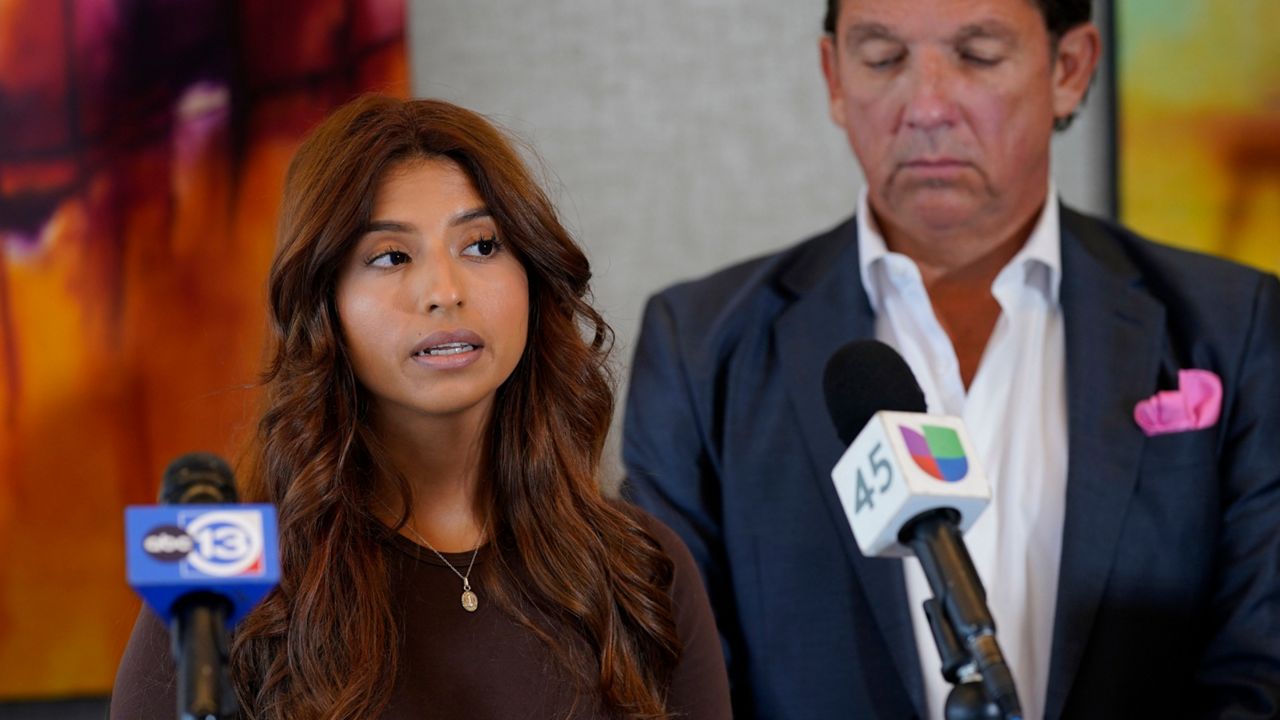 Ashley Solis, left, the first woman among several plaintiffs to file lawsuits accusing Cleveland Browns quarterback Deshaun Watson of sexual assault or harassment, speaks as her attorney Tony Buzbee stands beside her during a news conference to give an update to the lawsuits Thursday, Aug. 4, 2022, in Houston. The NFL is appealing a disciplinary officer's decision to suspend Watson for six games for violating the league's personal conduct policy. (AP Photo/David J. Phillip)