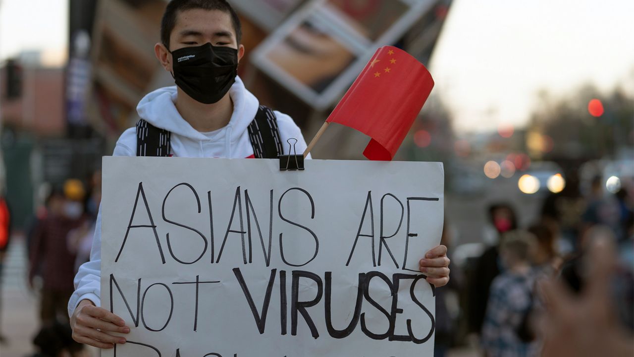 A demonstrator participates at a rally "Love Our Communities: Build Collective Power" to raise awareness of anti-Asian violence outside the Japanese American National Museum in Little Tokyo in Los Angeles Saturday, March 13, 2021. (AP Photo/Damian Dovarganes)