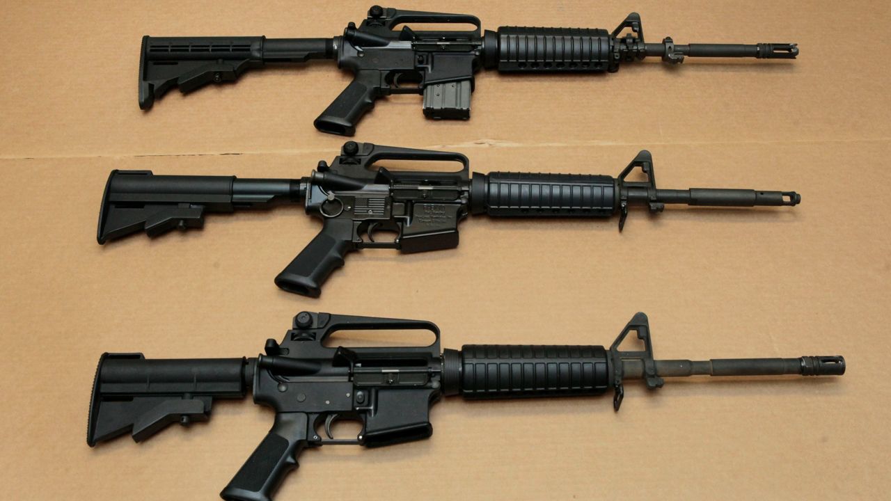 Three variations of the AR-15 rifle are displayed. (AP Photo/Rich Pedroncelli, File)