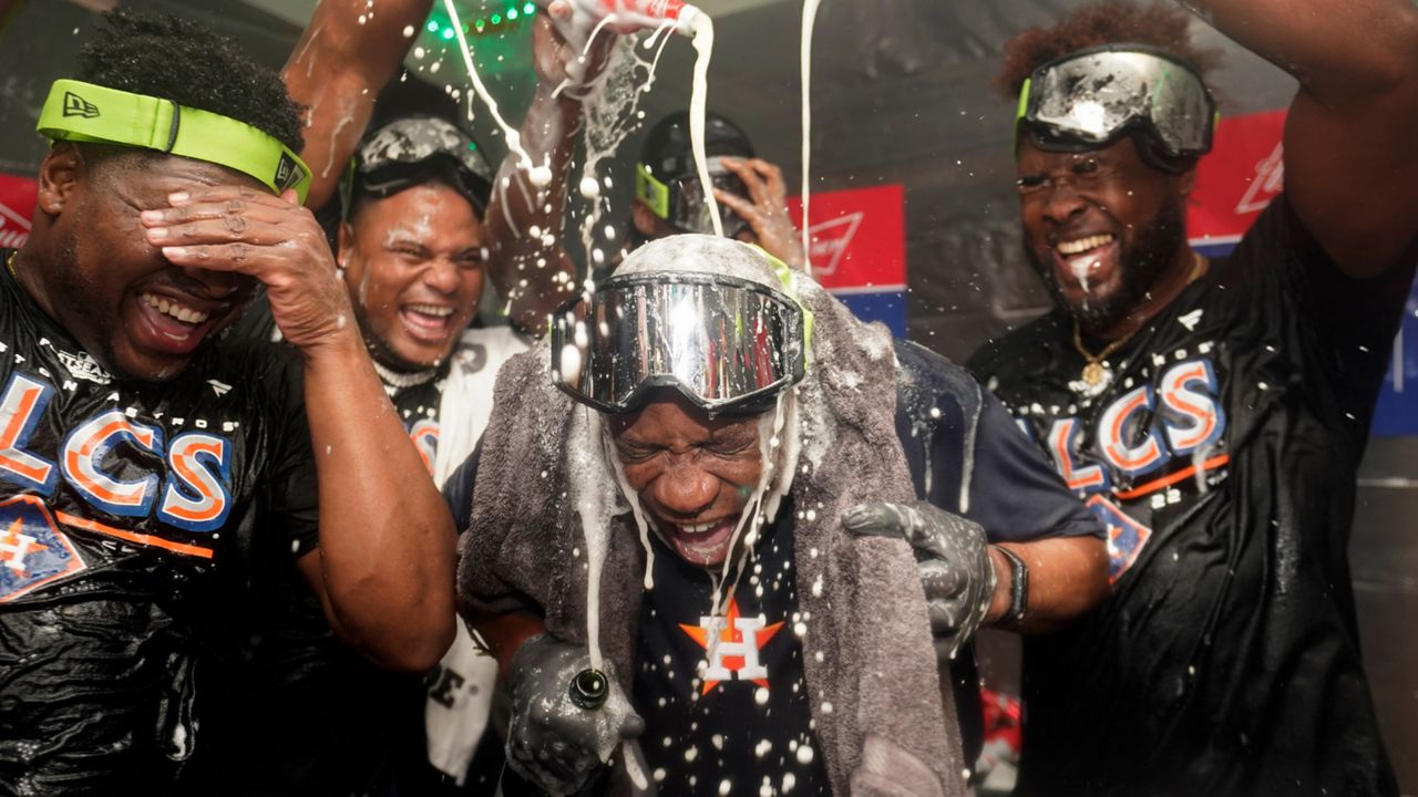 Houston Astros manager Dusty Baker Jr., center, celebrates with pitcher Hector Neris, left, and pitcher Cristian Javier, right, after defeating the Seattle Mariners in Game 3 of an American League Division Series baseball game Saturday, Oct. 15, 2022, in Seattle. (AP Photo/Abbie Parr)