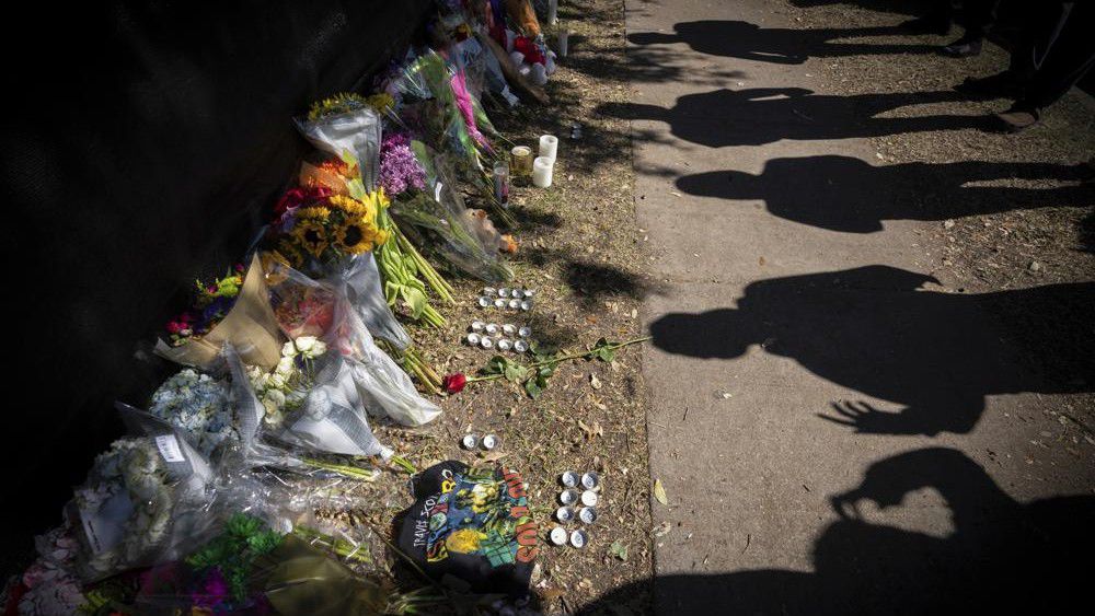 Visitors cast shadows at a memorial to the victims of the Astroworld concert in Houston on Sunday, Nov. 7, 2021. (AP Photo/Robert Bumsted)