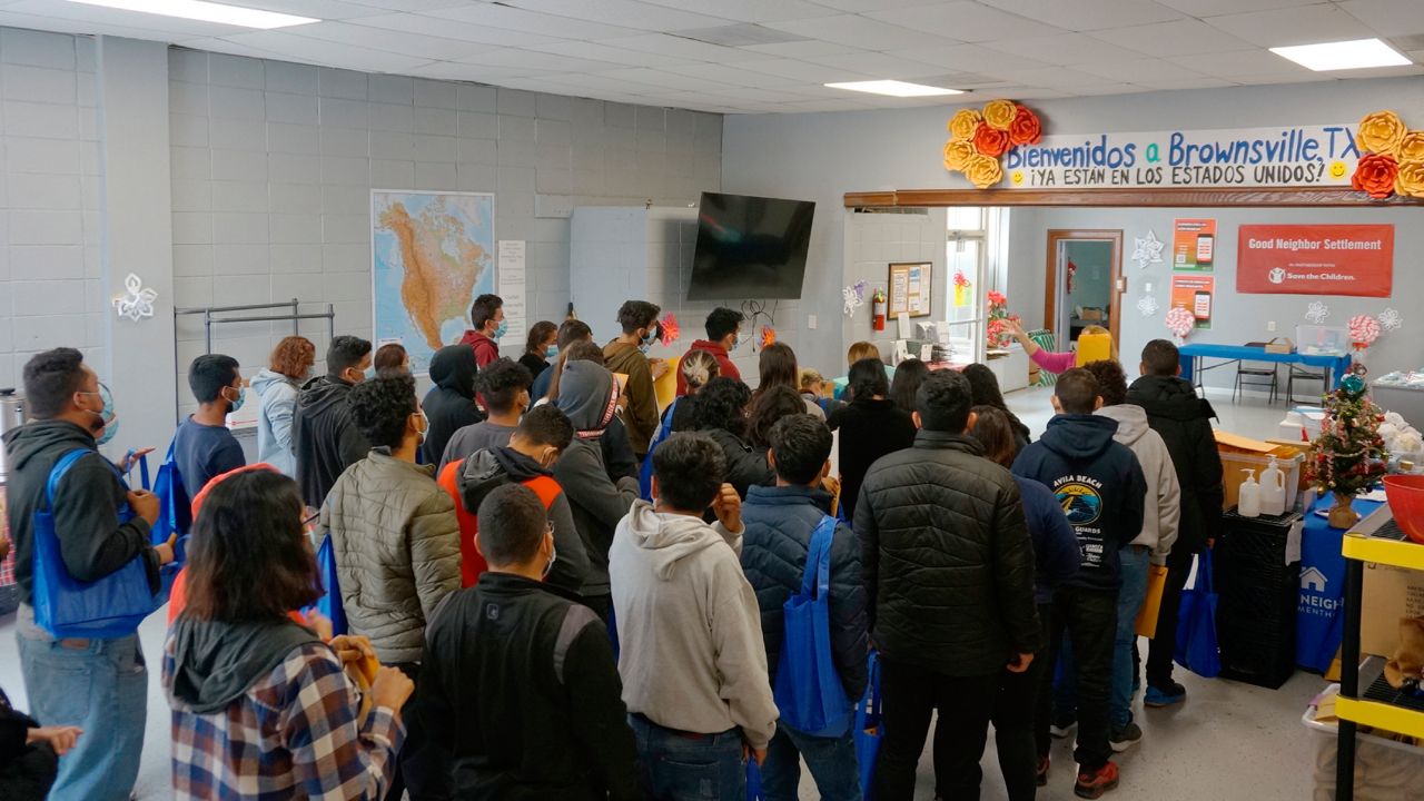 People line up inside the migrant welcome center across from the bus station in Brownsville, Texas, on Friday, Dec. 16, 2022. Volunteers from Team Brownville at the center handed out food and necessities, like toothpaste and socks, to migrants that U.S. officials detained and released across the street. Most of Friday's group said they were from Nicaragua, with a few from the Dominican Republic. (AP Photo/Giovanna Dell'Orto)