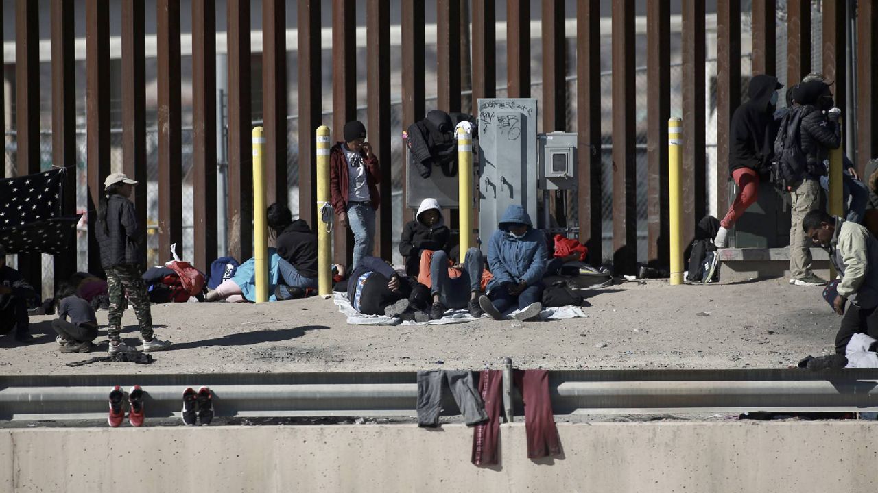 Migrants wait on the the border between Mexico and the United states, as seen from Ciudad Juarez, Mexico, Sunday, Jan. 8, 2023. (AP Photo/Christian Chavez)