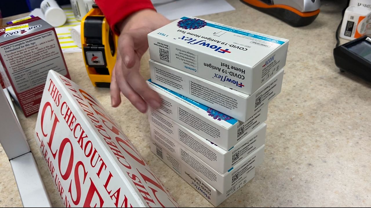 A stack of at-home COVID-19 tests being sold at Smith Pharmacy in Little Chute