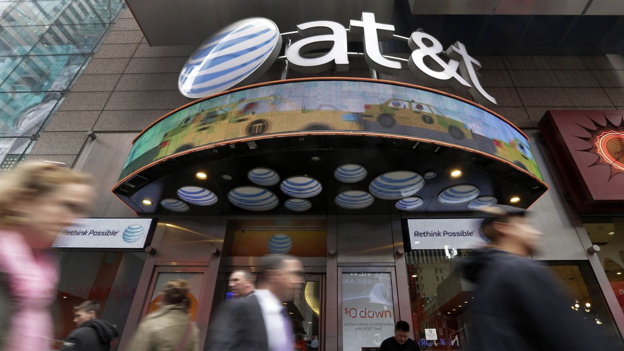 People pass an AT&T store in New York's Times Square. (AP Photo/Manuel Balce Ceneta, File)