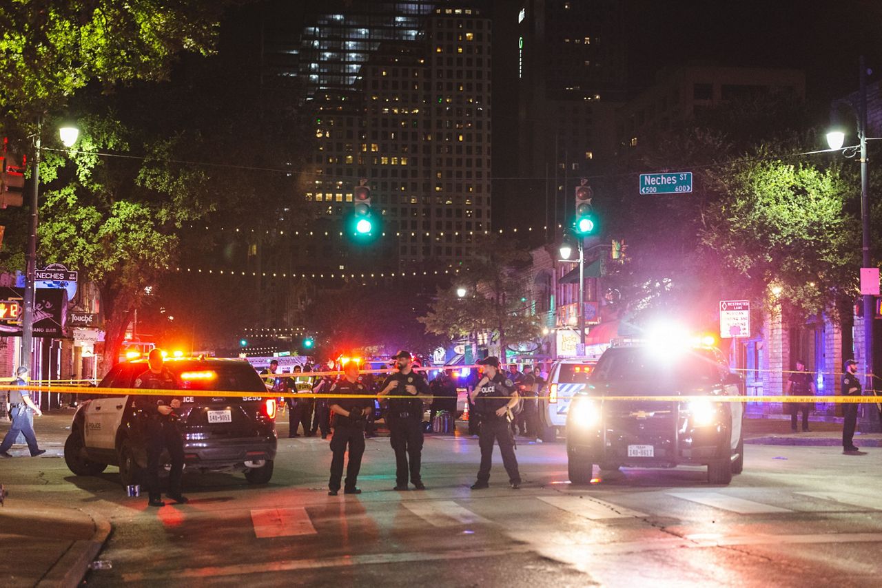 Police and a barricade are visible on 6th Street in downtown Austin, Texas, following a shooting that injured 13 in this image from June 12, 2021. (Courtesy: Metro Video Services, LLC.)