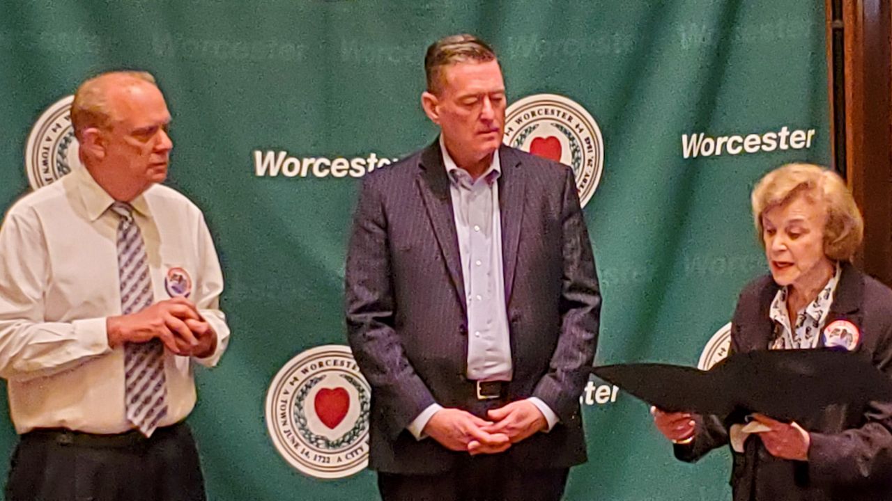Mayor Joe Petty (left) and state Senator Harriette Chandler (right) participate in Friday's open house to say goodbye to outgoing city manager, Ed Augustus (center).