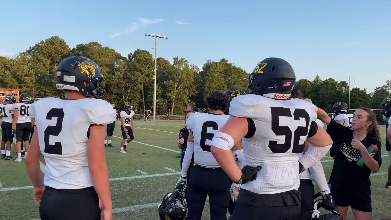 Topsail High School Pirates nose guard Austin Hobson stands with his team cheering on the offense in Friday's game against Dixon High School. (Spectrum News 1/Alex Wilkinson)