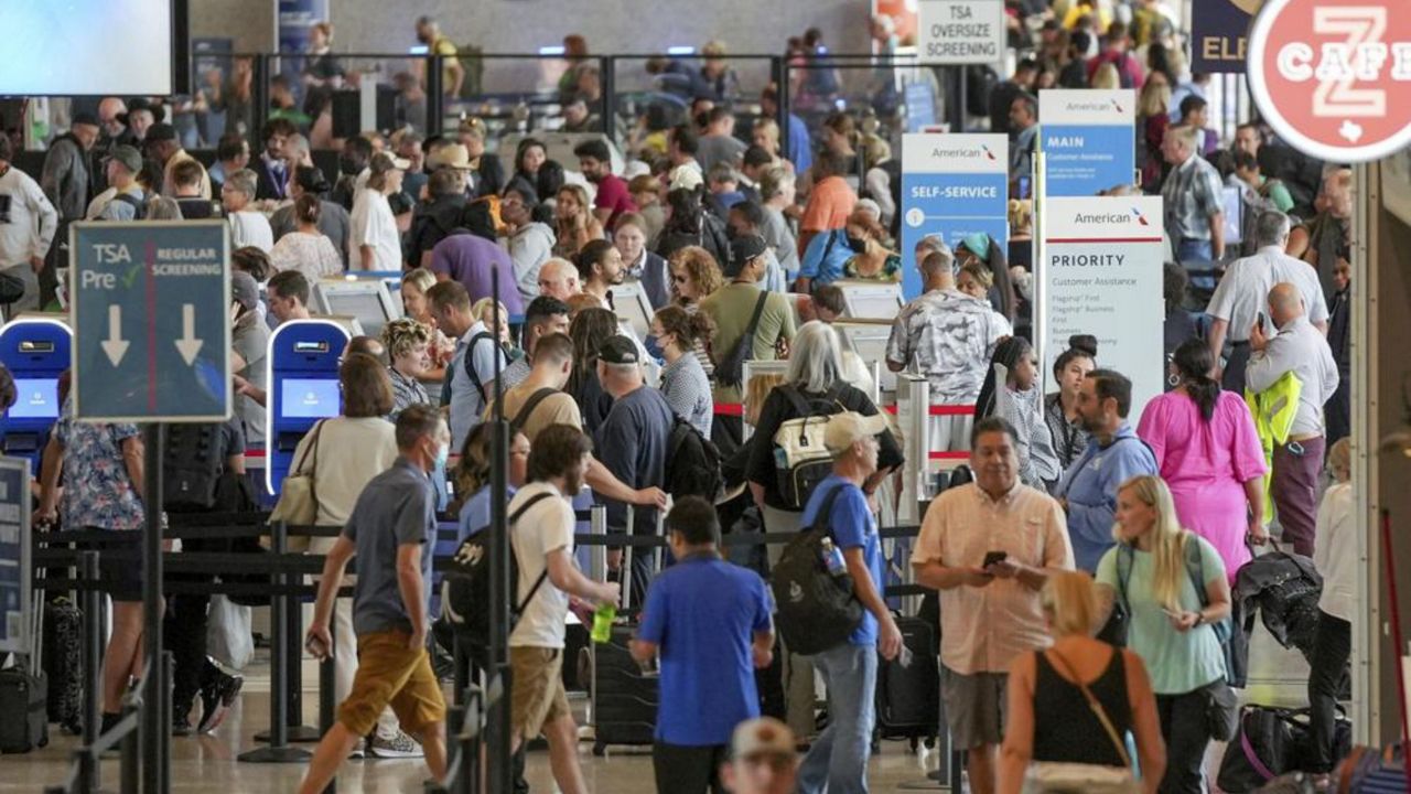 Travelers line up at the ticketing counters after a power outage at Austin-Bergstrom International Airport on Wednesday, Sept. 7, 2022, in Austin, Texas. An early morning power outage at the airport caused flight delays that continued even after electricity was restored. (Jay Janner/Austin American-Statesman via AP)