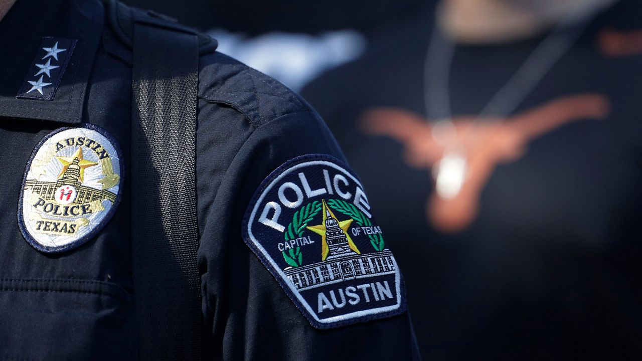 Members of the Austin Police Department march with members of the University of Texas football team to the State Capitol in Austin, on Thursday, June 4, 2020. (AP Photo/Eric Gay)