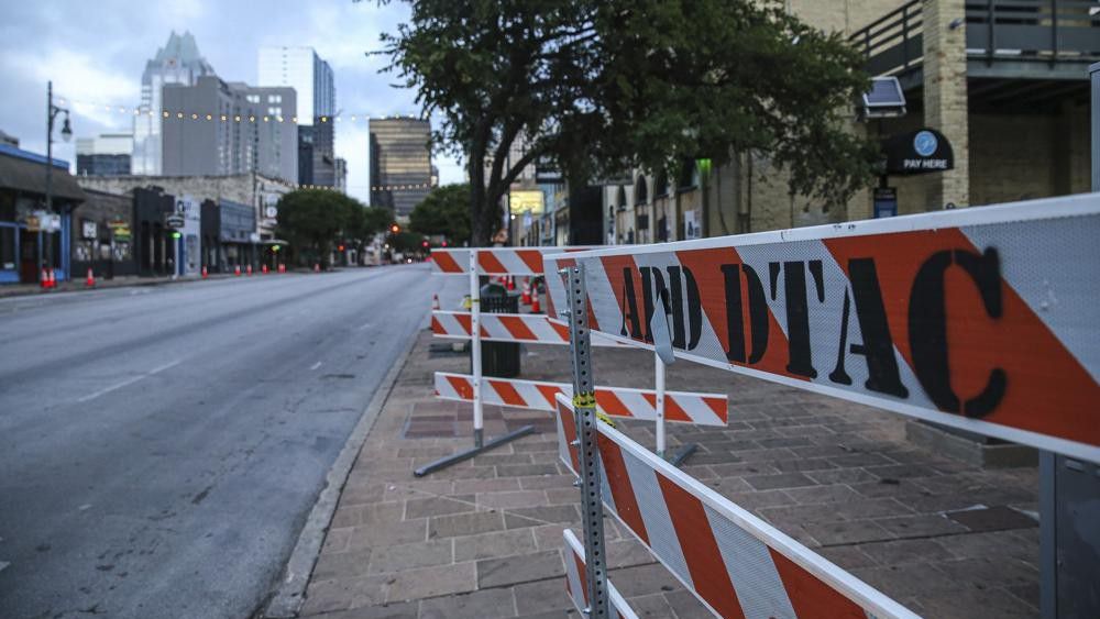 Road block barriers sit on the sidewalk on 6th Street after an early morning shooting on Saturday, June 12, 2021 in downtown Austin, Texas. Authorities say someone opened fire on the busy entertainment district wounding several people before getting away. (Aaron Martinez/Austin American-Statesman via AP