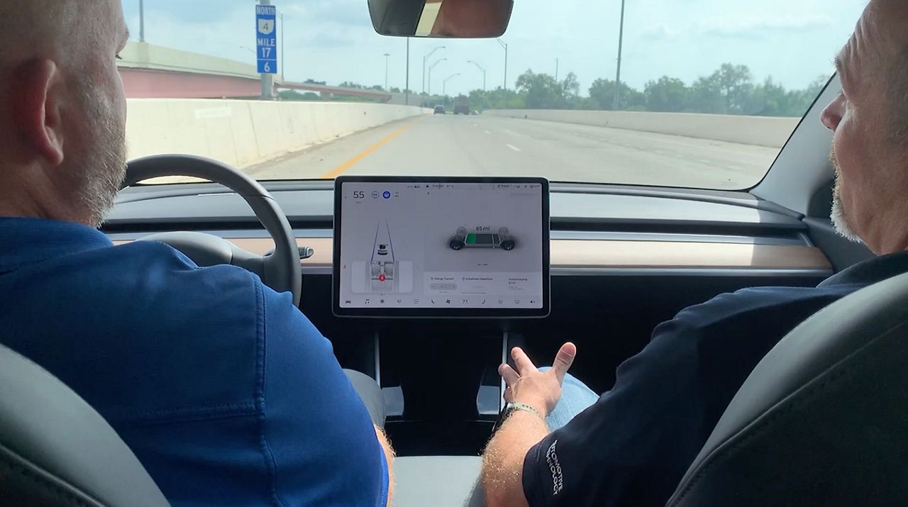 Kent gets a test ride in the Tesla 