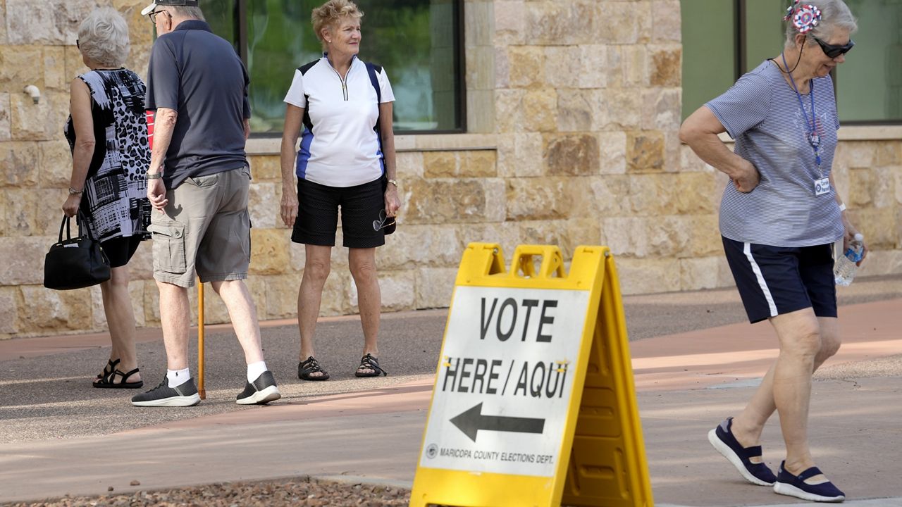 Voters arrive to vote on the first day of early in-person voting at Surprise City Hall Wednesday, Oct. 9, 2024, in Surprise, Ariz. (AP Photo/Ross D. Franklin)