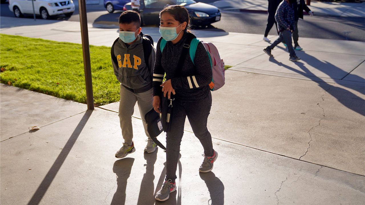 Students arrive at Newhall Elementary School Thursday, Feb. 25, 2021, in Santa Clarita, Calif. Elementary school students returned to school this week in the Newhall School District. (AP Photo/Marcio Jose Sanchez)