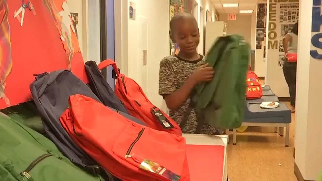 Kids receive bookbags and supplies