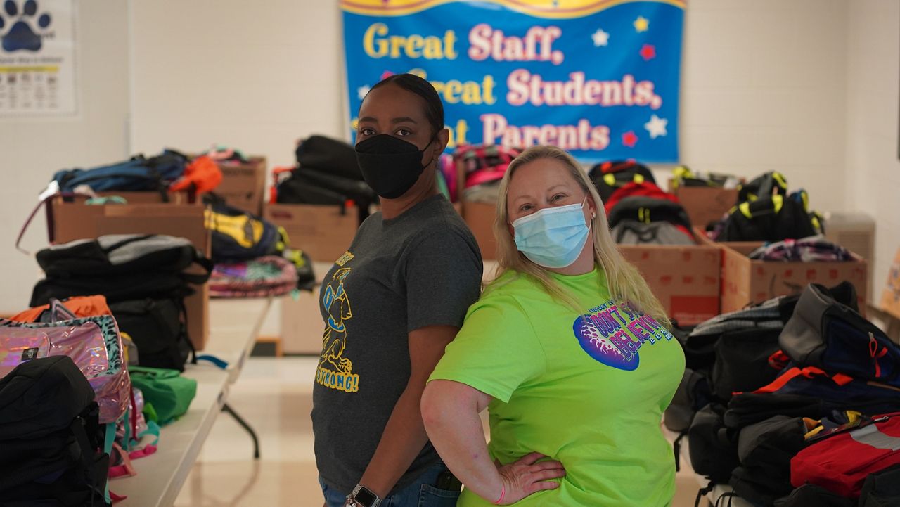 Hundreds of donated backpacks given to school children