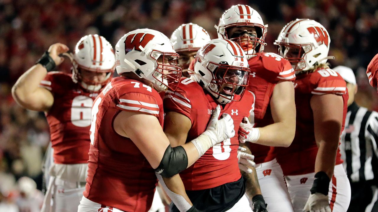 Wisconsin's Braelon Allen is congratulated by teammates during overtime of an NCAA college football game