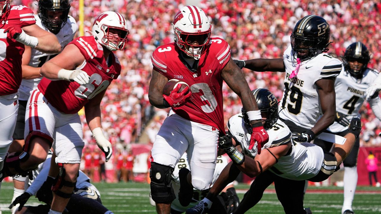 Wisconsin's Tawee Walker (3) gets away from Purdue's Dillon Thieneman (31) for a touchdown during the second half of an NCAA college football game Saturday, Oct. 5, 2024, in Madison, Wis. (AP Photo/Morry Gash)